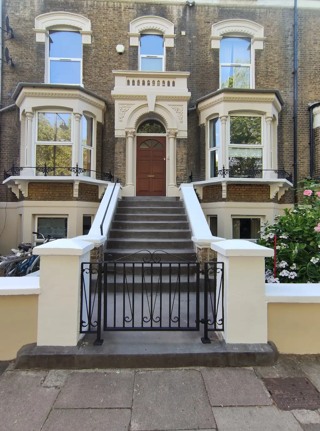 Victorian terraced house with freshly painted white render and period stonework