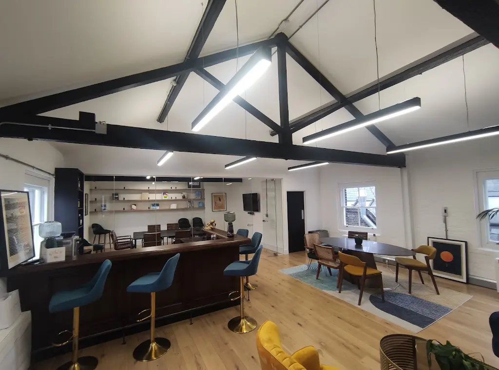 Commercial office interior with white painted walls and black exposed beams