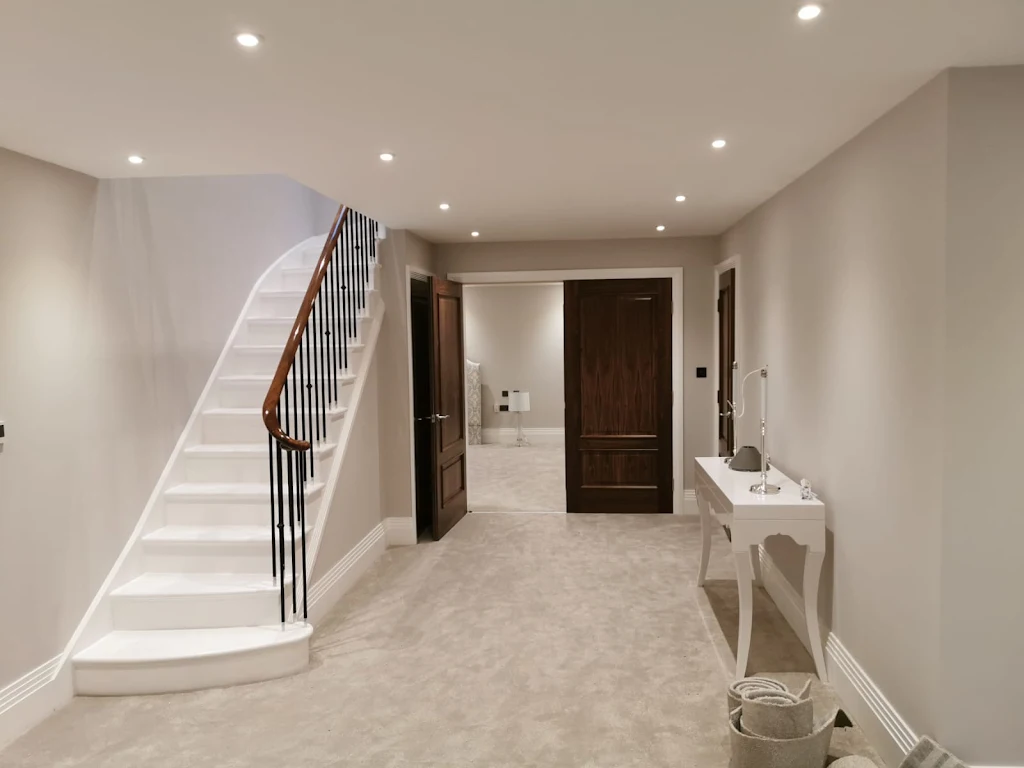 Entrance hall with painted staircase and neutral walls