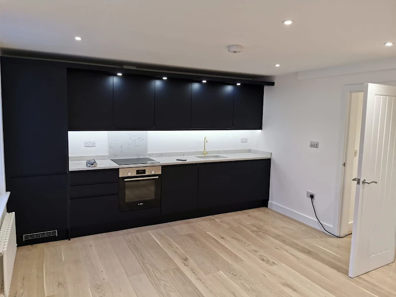 Modern kitchen with matte black painted cabinets and under-cabinet lighting
