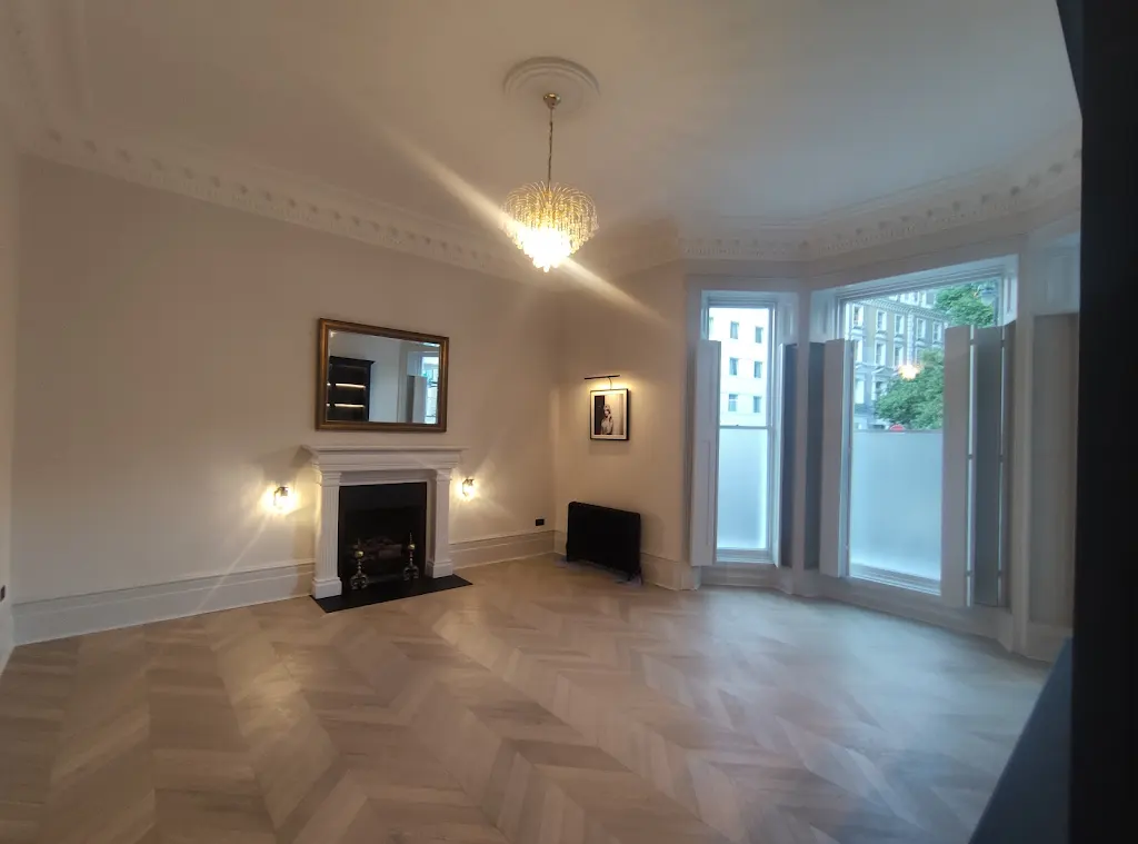 Interior painting of period living room with fireplace and herringbone floor