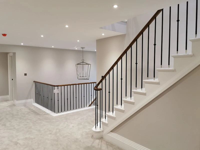 Staircase landing with freshly painted neutral walls and white woodwork